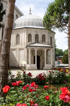 Exterior view through a rose bed of the Tomb of the Princes - children of Sultan Murad III, constructed towards the later 16th century in Istanbul, Turkey. 