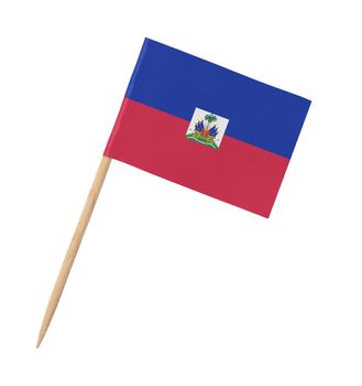 Small paper flag of Haiti on wooden stick, isolated on white