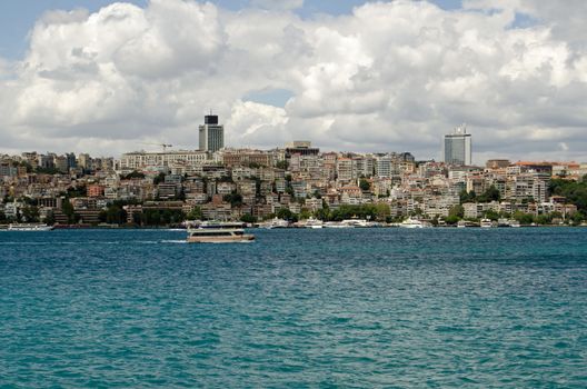 View of the Beyoglu district of Istanbul as seen from a ferry on the Bosphorus Strait, Turkey.  The suburb, on the European side of the city has many apartments and offices.