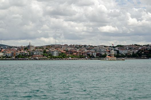 View from the Bosphorus strait of the Uskudar district of Istanbul on the Asian side of the city with the landmark Maiden's Tower to the right hand side. 