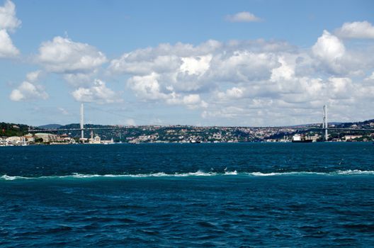 View from the sea of the First Bosphorus Bridge crossing the strait between Europe and Asia in Istanbul, Turkey.