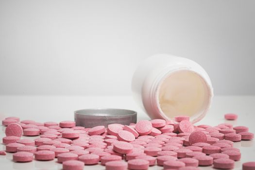 Pile of tablets in white background. Concept of prescription medicine, vitamins, nutritional supplements of drug abuse