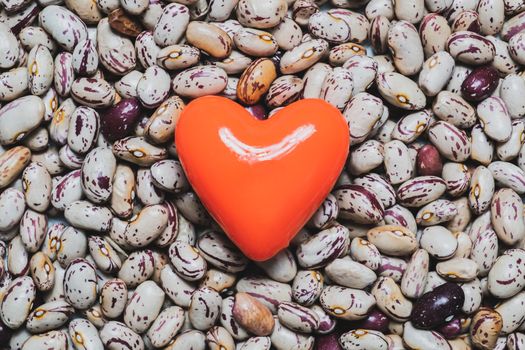 Heart shape on a heap of beans. Food for the heart's health, healthy eating concept.