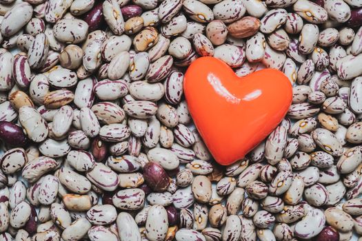 Heart shape on a heap of beans. Food for the heart's health, healthy eating concept.