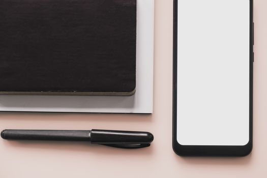 Business flat lay on pastel background. Smartphone, writing pen and notebook organizer on minimalistic background