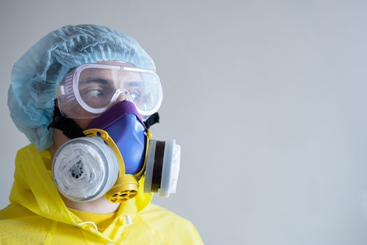 Man in protective face mask and eyeglasses, copy space . Medical personell, scientist or MD in work gear, concept of covid-19, virus, epidemic and vaccine development