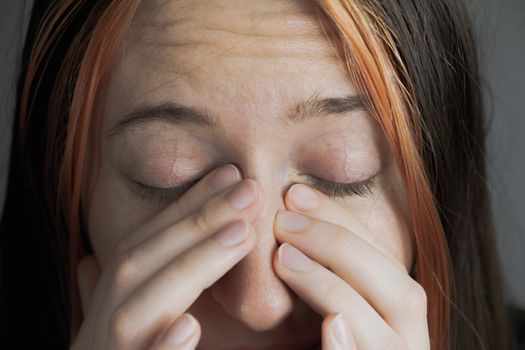 Touching face with fingers - concept of bringing virus or infection. Woman trying to sneeze or rubbing hypertension eyes, personal hygiene or health care