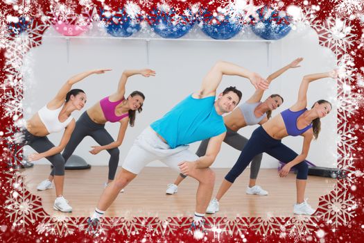 Class doing stretching exercise in fitness studio against snow