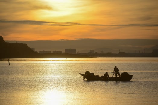 Silhouette fisherman fishing in sea in morning.