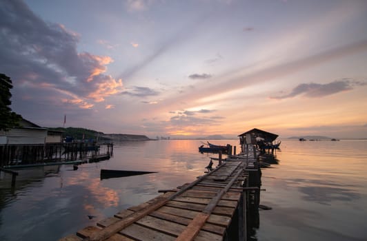 Wooden hut connected with bridge at sea near fishing village at Jelutong, Penang, Malaysia.