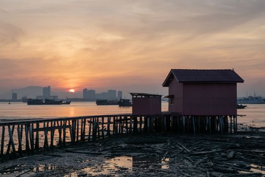 Red temple at heritage Georgetown Tan Jetty during sun rise hour.