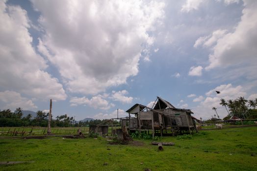 Dilapidated traditional wooden hut in the farm.