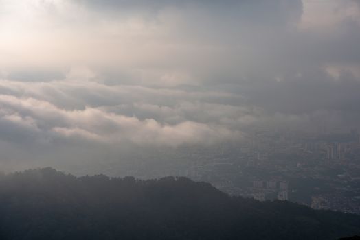 Sea Cloud cover Georgetown in hazy morning. View from Penang Hill.