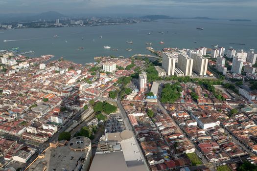 Aerial view Penang Georgertown in evening with shadow of KOMTAR building. Background is Straits of Malacca.