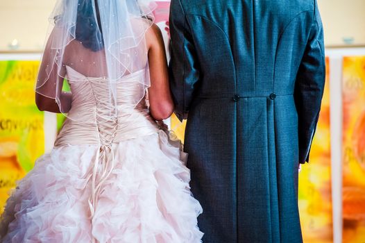 Unrecognizable bride and groom at the alter in church UK