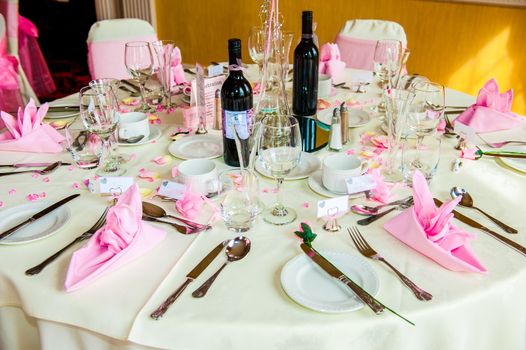 Table set for a Wedding reception with bottles of wine UK