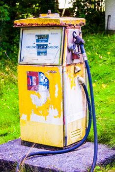 Rusted old gas pump in derelict garage UK