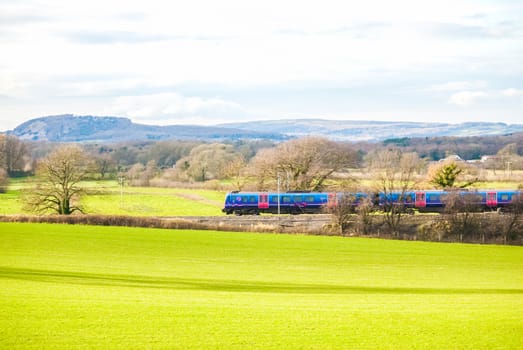 A TransPennine Express passenger train in the countryside