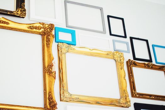 Empty art frames on gallery wall, decor and design details