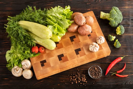 vegetables and spices on a wooden cutting board