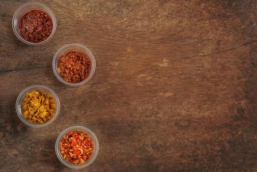 thai style chili paste in plastic bowl over wooden background