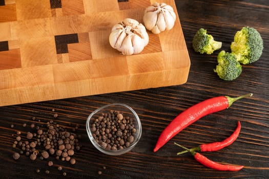 Vegetables and spices on a wooden cutting board