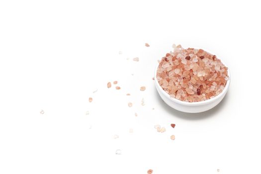 Himalayan pink salt in bowl on white background