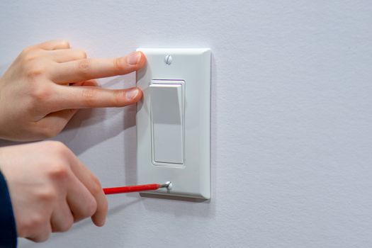 Attaching a white platband to an electric wall switch