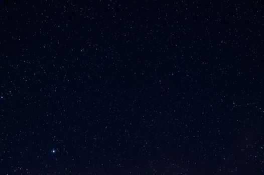 Long exposure night photo of a bright stars. A lot of stars with constellations. Far from the city. Night landscape.