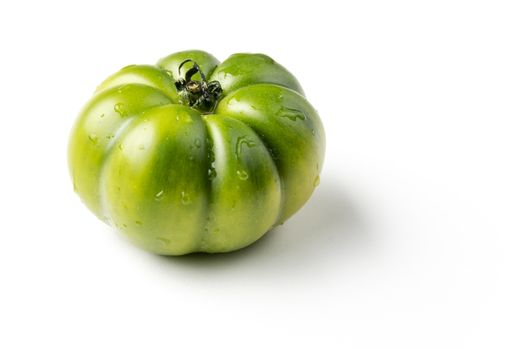 fresh green tomato on white background