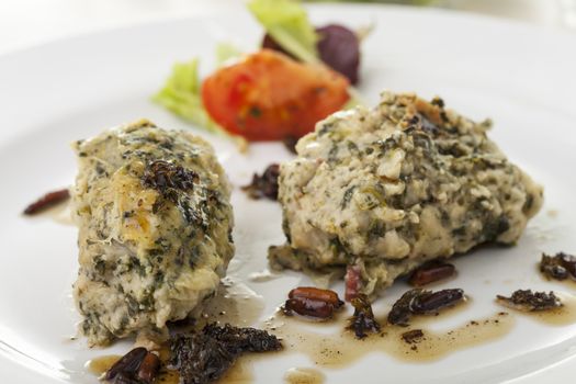 italian strangolapreti dumplings on a plate