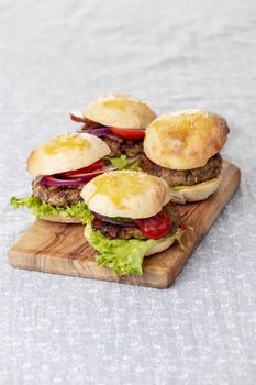four small hamburges on a board
