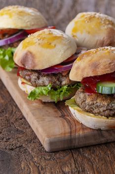 four small hamburges on a board