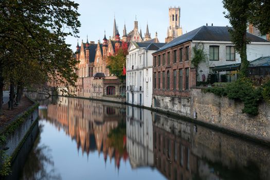 Early morning mood an the channels of Bruges with old buildings reflecting in the water, Belgium