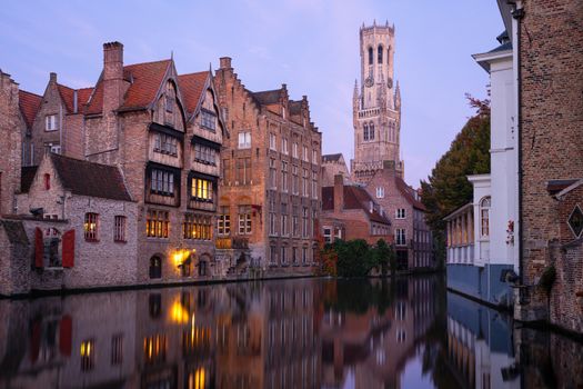 Early morning mood an the channels of Bruges with old buildings reflecting in the water, Belgium