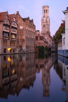 Early morning mood an the channels of Bruges with old buildings reflecting in the water, Belgium