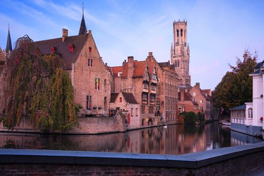 Early morning mood an the channels of Bruges with old buildings reflecting in the water, Belgium