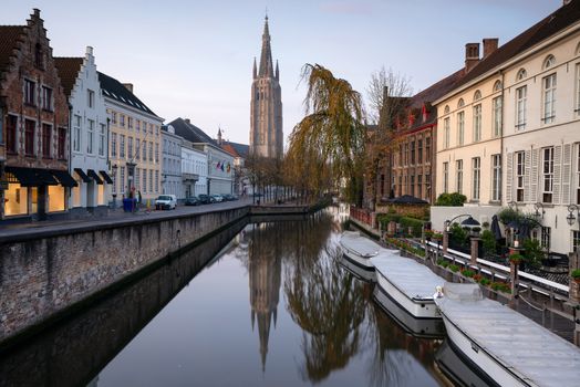 Early morning mood an the channels of Bruges with old buildings reflecting in the water, Belgium