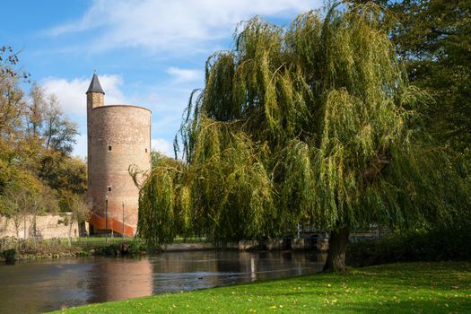 Panoramic image of the Minnewaterpark in Bruges with historic buildings, trees and idyllic canals, Flanders, Belgium