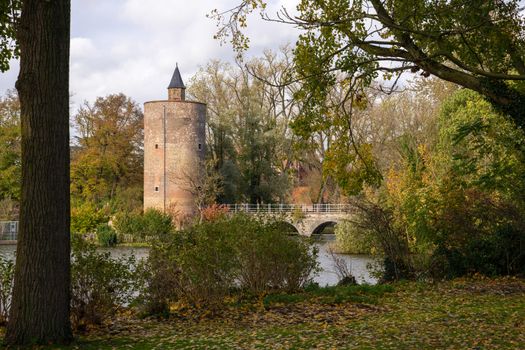 Panoramic image of the Minnewaterpark in Bruges with historic buildings, trees and idyllic canals, Flanders, Belgium