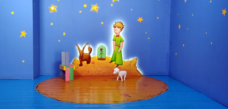 Kid zone surrounded with stars and a little boy painting on the wall along with sheep and dog in Korea