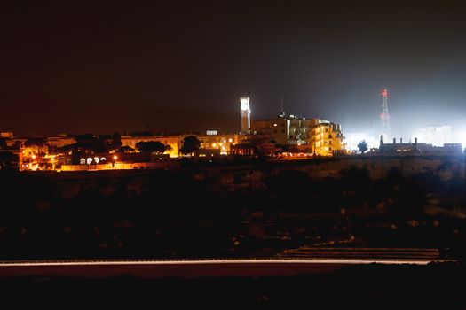 Night panorama view of illuminated roads and grounds around Mdina - old capital of Malta. Shooted with long exposure.