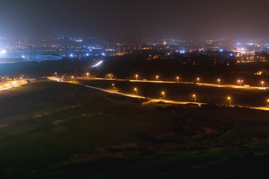 Night panorama view of illuminated roads and grounds around Mdina - old capital of Malta. Shooted with long exposure.