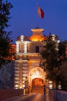 Illuminated Gate of Mdina, ancient capital of Malta. Night view on entrance into ancient town.