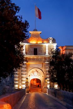 Illuminated Gate of Mdina, ancient capital of Malta. Night view on entrance into ancient town.