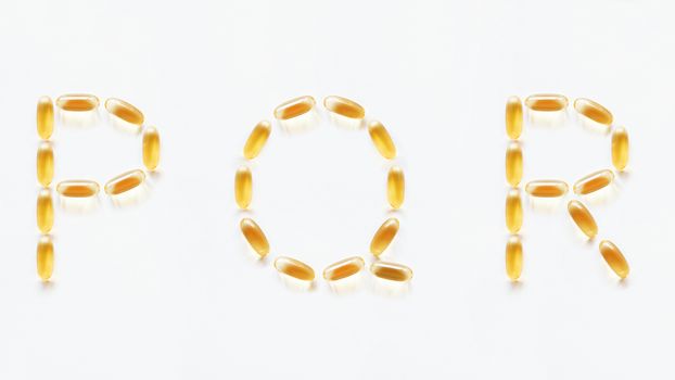 Letters P, Q, R made of transparent yellow pills. Part 6 of latin alphabet in medical style. Isolated on white background.