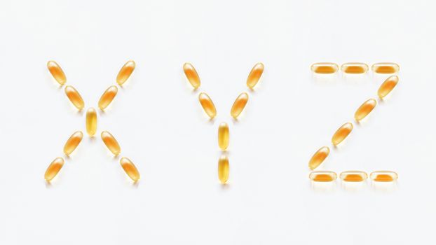 Letters X, Y, Z made of transparent yellow pills. Part 9 of latin alphabet in medical style. Isolated on white background.