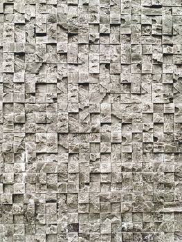 Outdoor wall made of grey decorative stones. Stone texture of building wall.