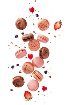 Fly french macarons. Levitate composition with different types colorful macaroons in motion falling or flying isolated on white background