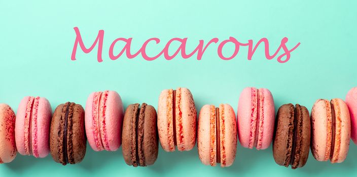 Macarons concept. Letters macarons on turquose bright bacground and row of french macarons